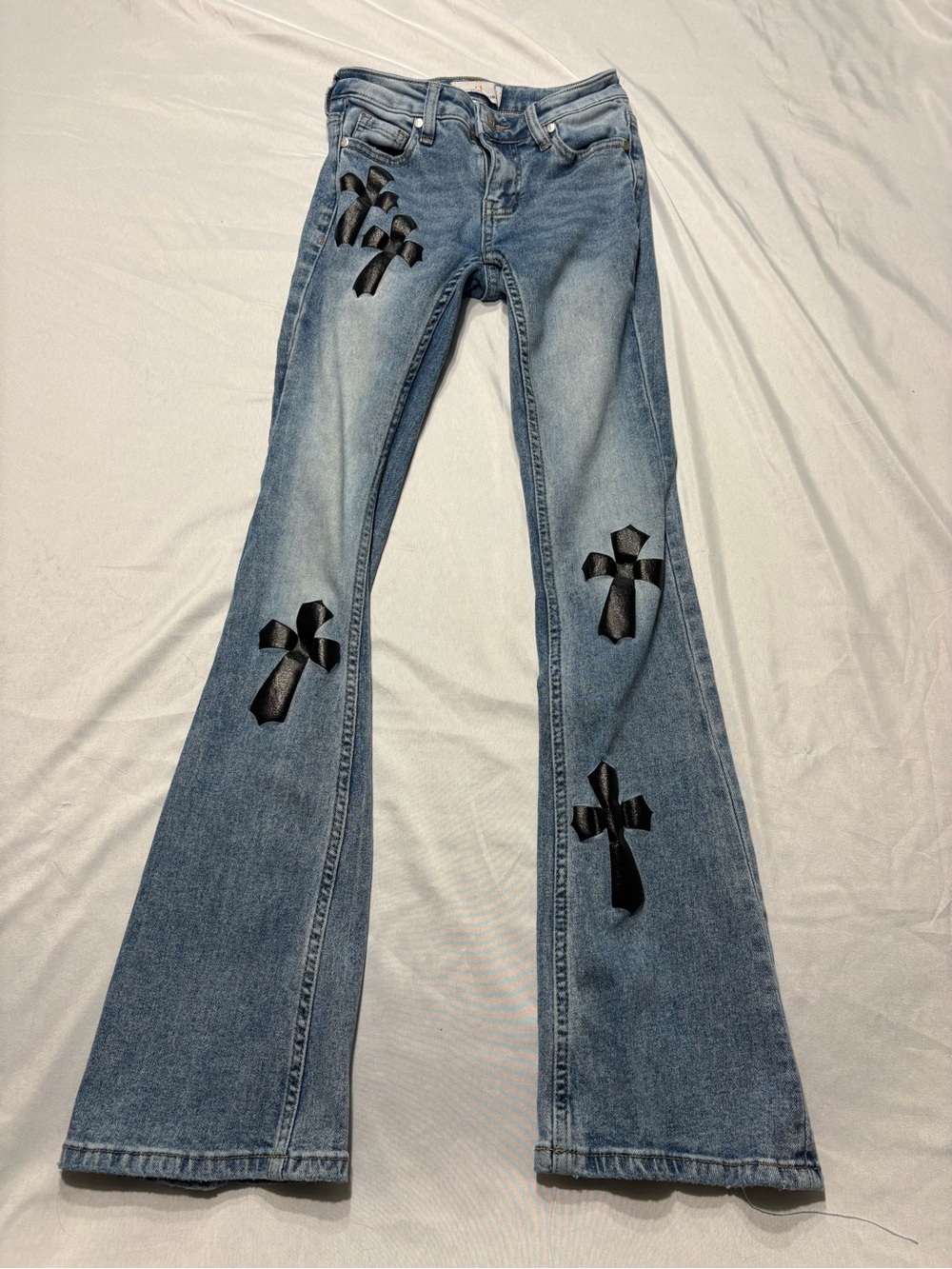 Light Blue Boot-Cut Jeans with Black Cross Appliqués